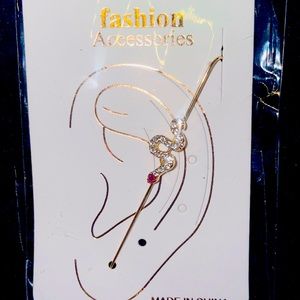Snake design earring that’s gold color with diamonds and a ruby.